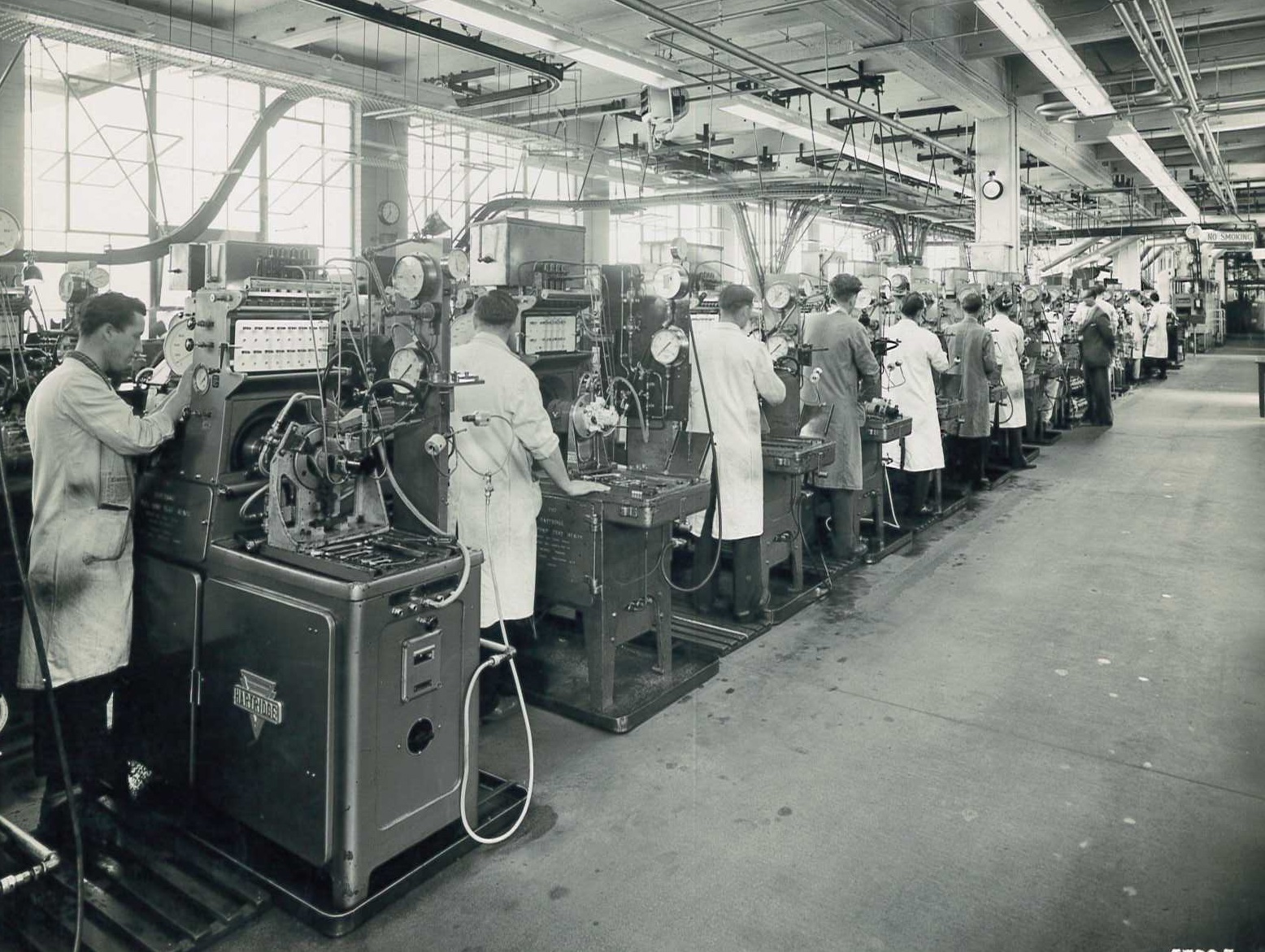 blakc and white image of engineers working on hartridge machines