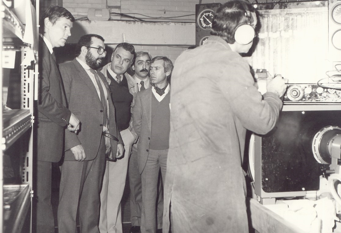 businessmen observing hartridge machine demo